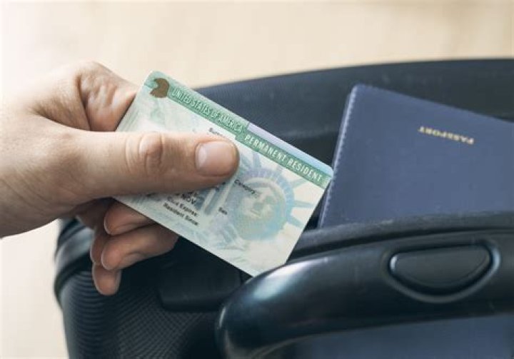 What happens if the spouse of a green card holder dies?